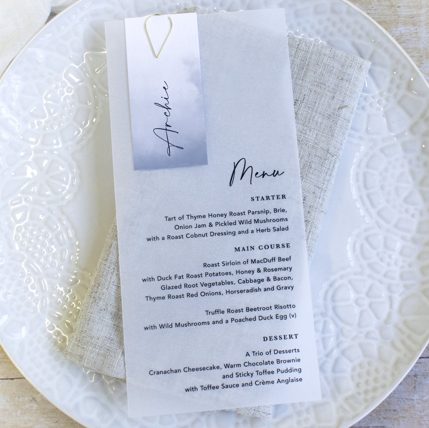Vellum wedding menu with guest name card in dusky blue