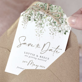greenery save the date cards finished with a rustic twine bow