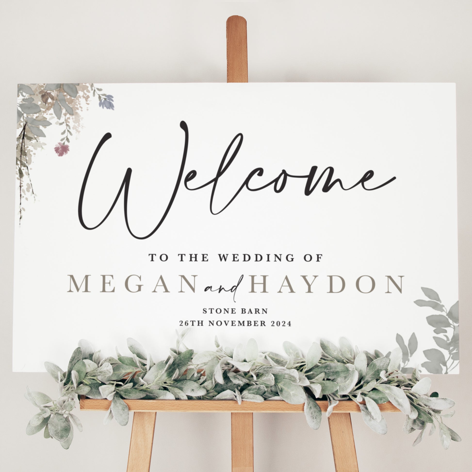 wedding welcome sign featuring sage green foliage 