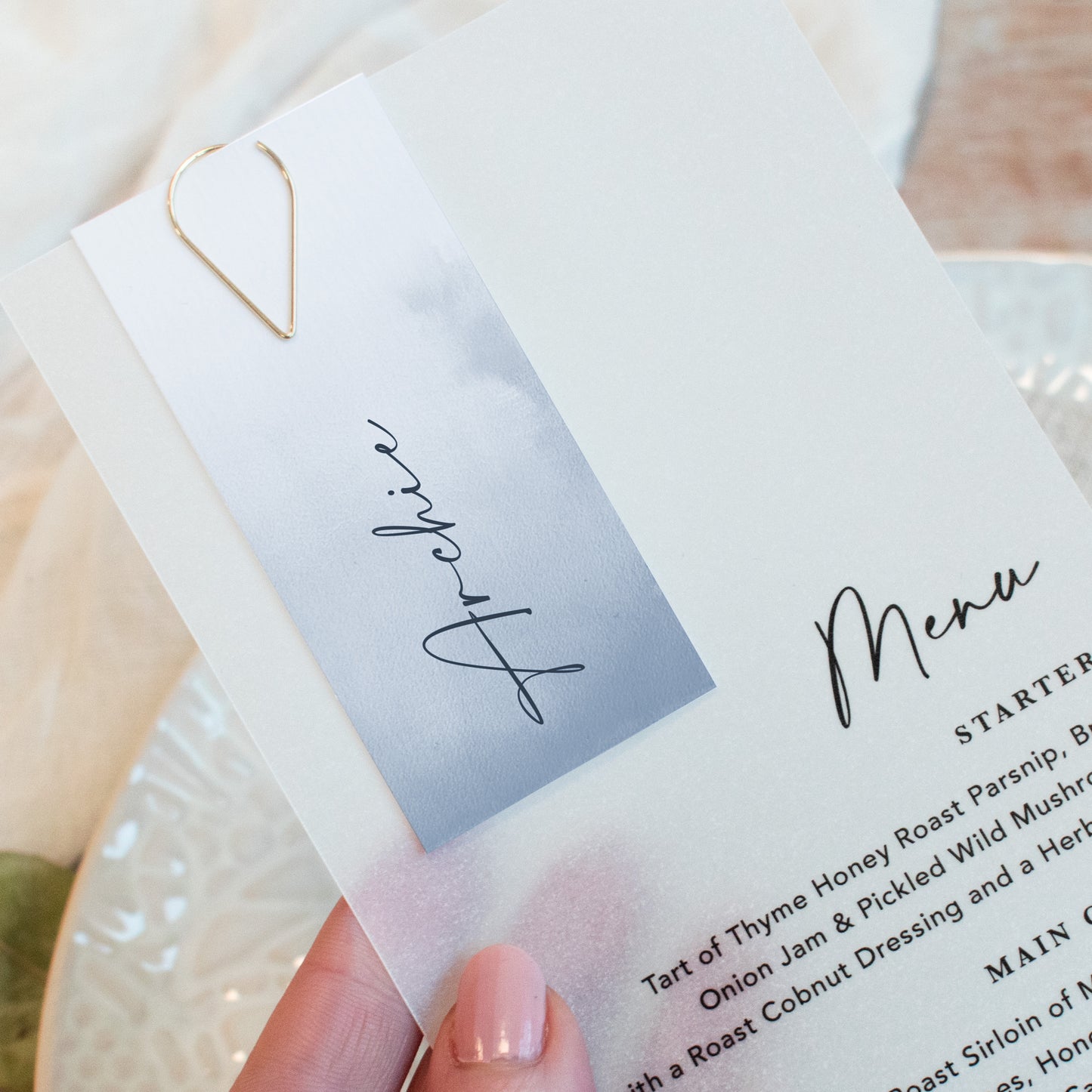 Vellum wedding menu with guest name card in dusky blue