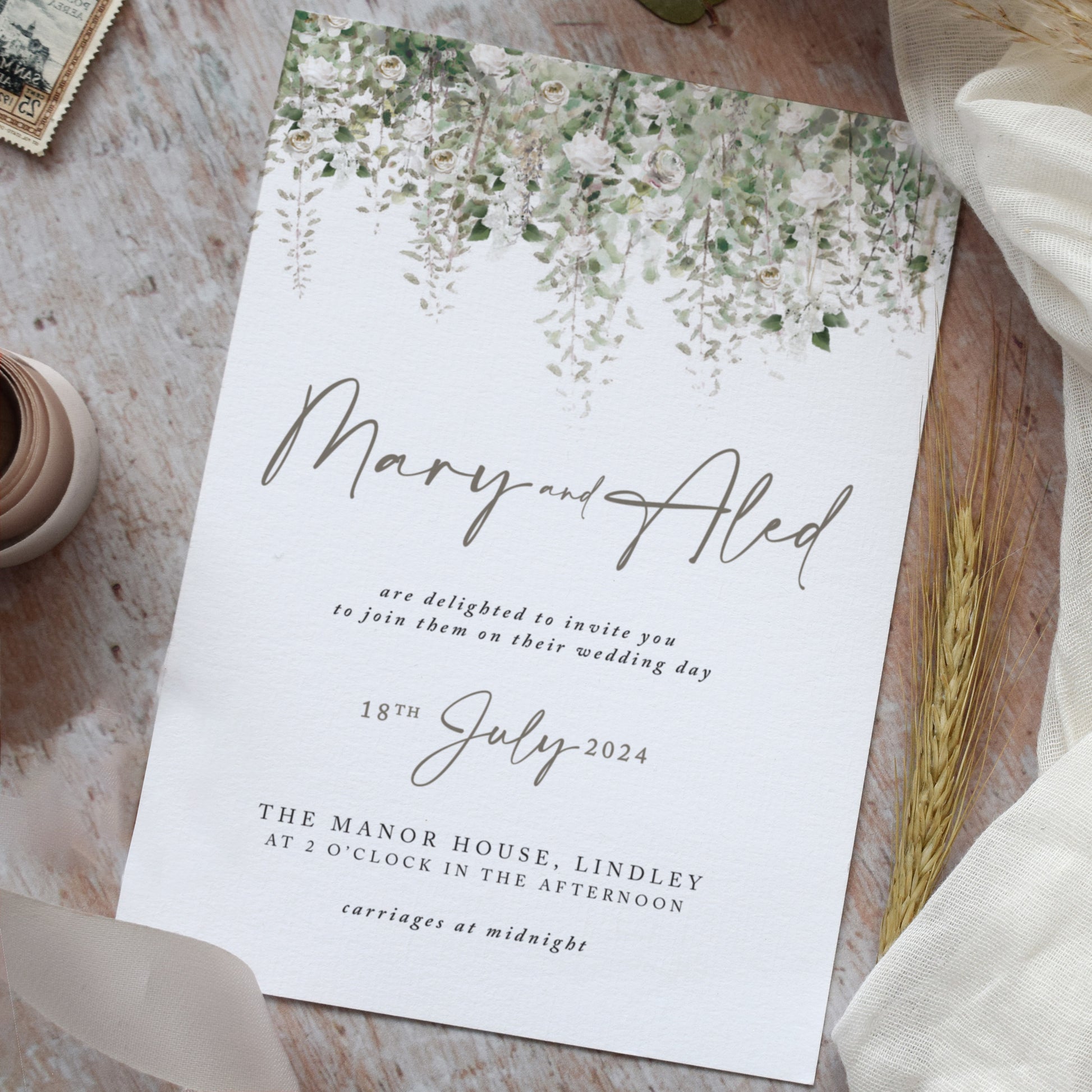 Rustic wedding invitations featuring sage green foliage