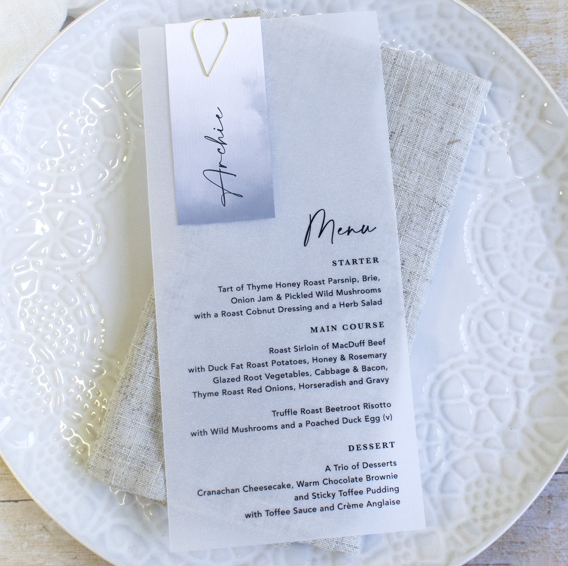 Vellum wedding menu with guest name card in dusky blue