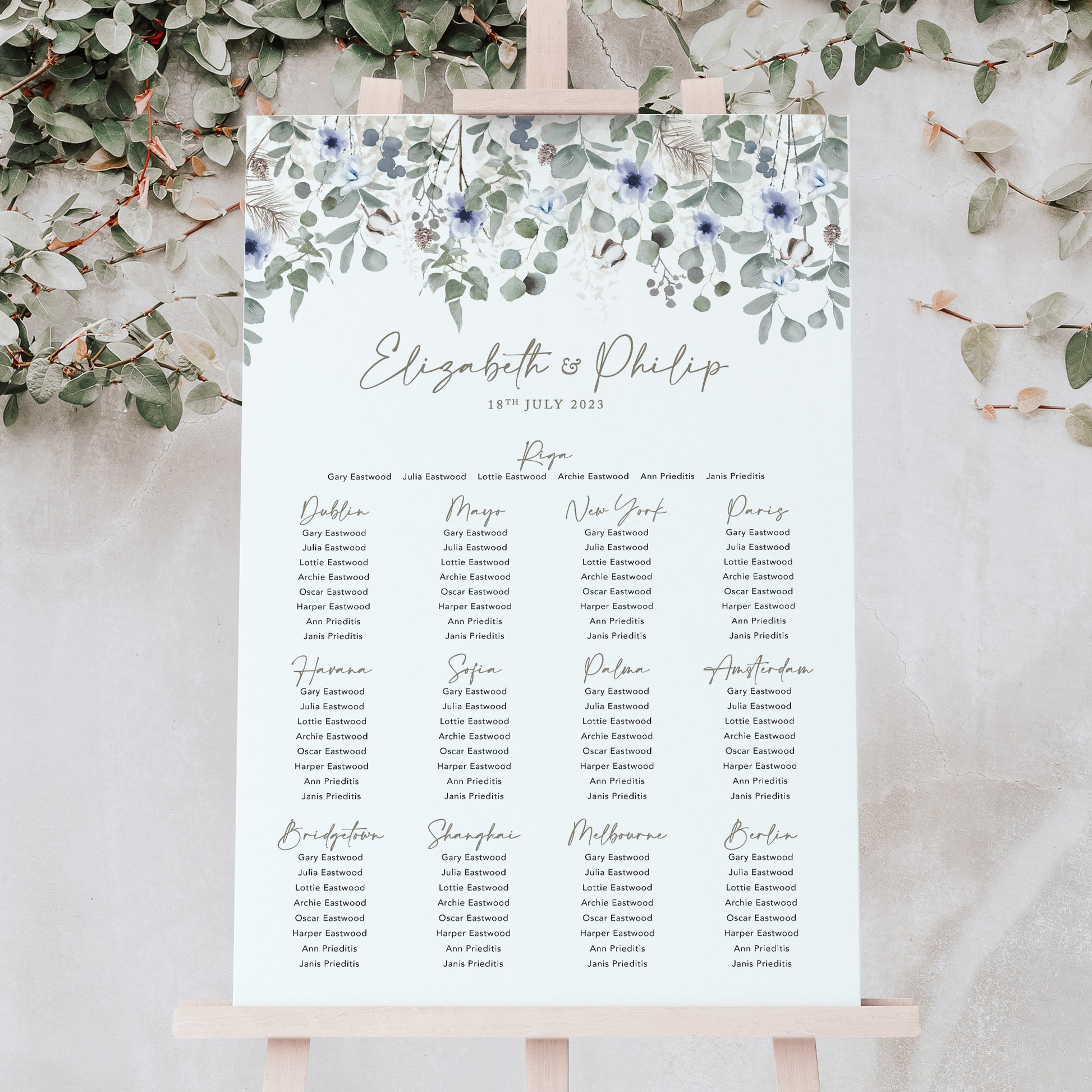 Sage green foliage and dusky blue wedding table plan for a winter wedding