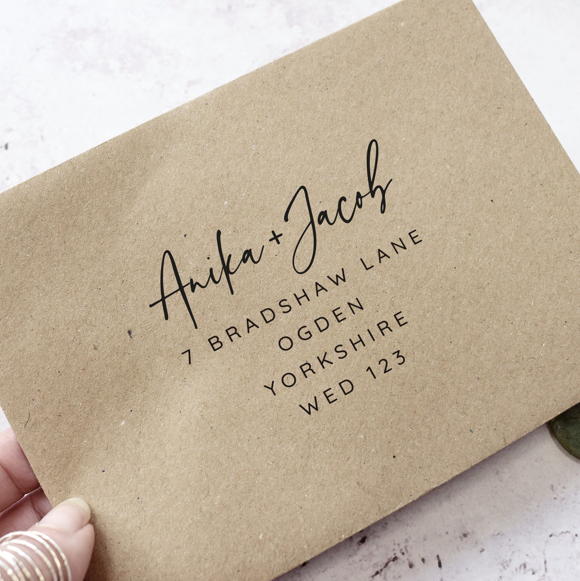 Rustic Kraft wedding envelopes printed with guest names and addresses